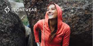 smiling woman wearing stonewear hoodie